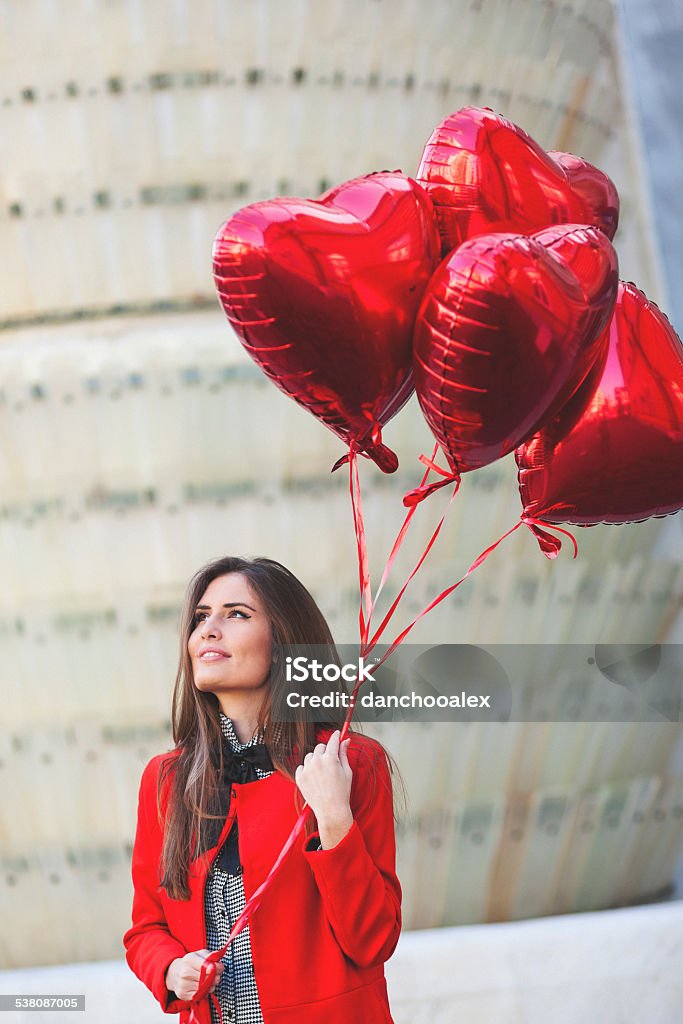Young woman with heart shaped balloons Portraits of a young woman with heart shaped balloons. Shallow DOF. Developed from RAW; retouched with special care and attention; Small amount of grain added for best final impression. Adobe RGB color profile. 20-29 Years Stock Photo