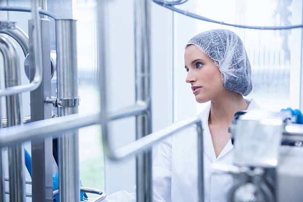 istock Portrait of a smiling scientist behind metal pipe 538087449