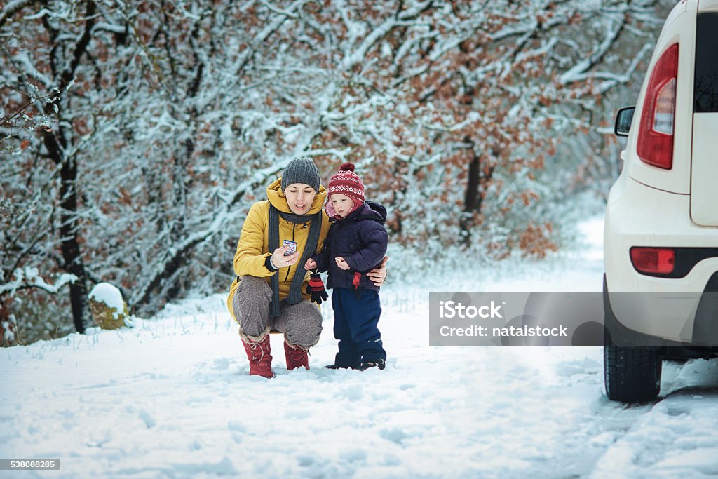 woman with a child on the winter road woman with a child on the winter road. emergency signwoman with a child on the winter road. emergency sign 2015 Stock Photo