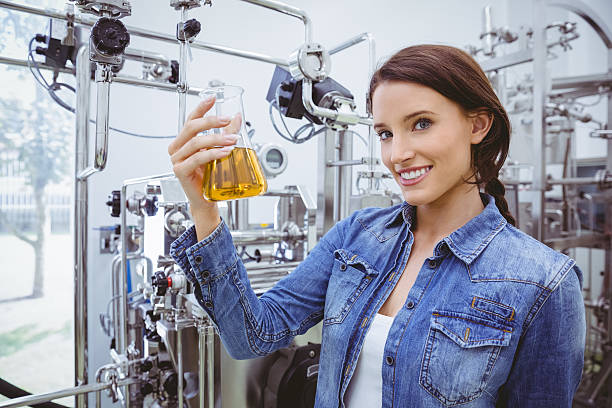 istock Smiling woman holding a beaker of beer 538088603