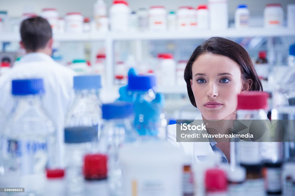 Portrait of a chemist behind medical sample Portrait of a chemist behind medical sample in lab 20-24 Years Stock Photo
