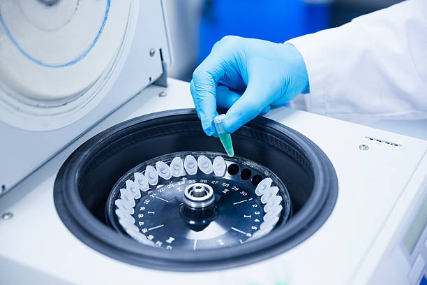 Close up of a chemist using centrifuge stock photo