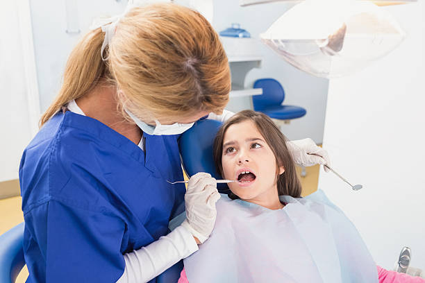 istock Pediatric dentist examining her young patient 538098979