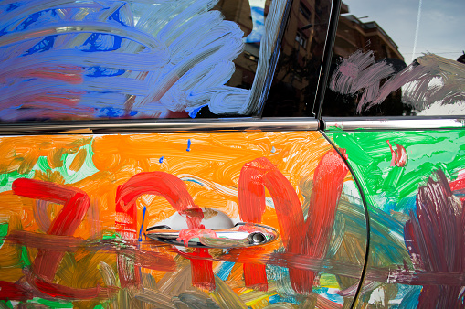 painted car with mix of colours by hooligans