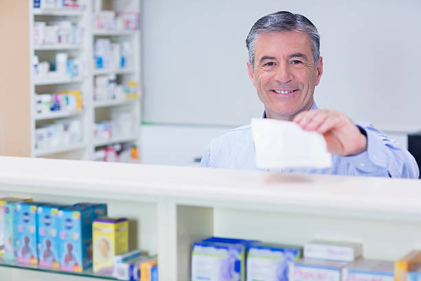 istock Pharmacist with grey hair holding a prescription 538101953