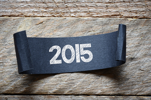 Black papper with 2015 on wooden background