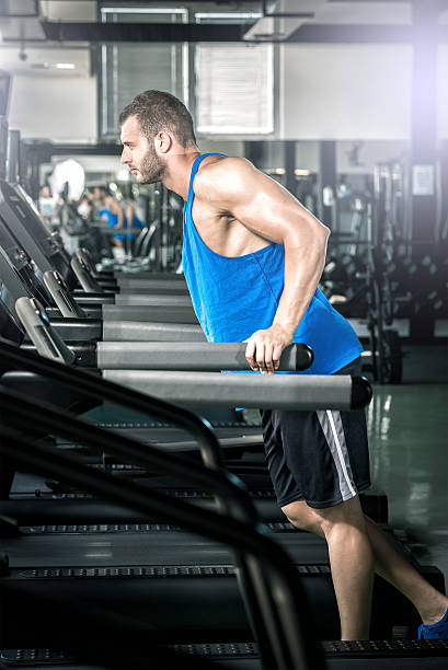 istock Young man running at treadmill in gym 538125567