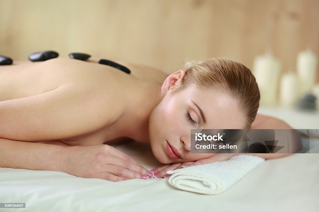 Beautiful young woman getting spa massage, lying on salon Young woman getting spa massage, lying on spa salon 2015 Stock Photo