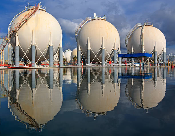 istock Petrochemical tanks in refinery and reflections on water 538142853