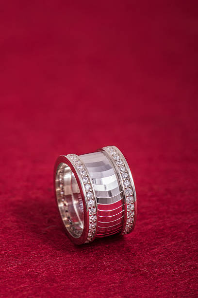 wedding ring with double row diamonds on red stock photo