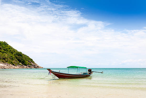 istock longtail boat on beach in Thailand 538143503