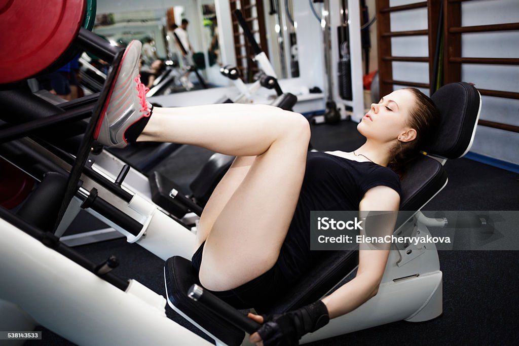 Woman at the gym on a sports simulator Buttocks Stock Photo