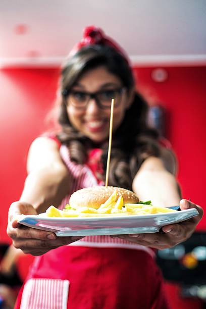 istock Fast Food Waitress Showing a Hamburger. 538144067