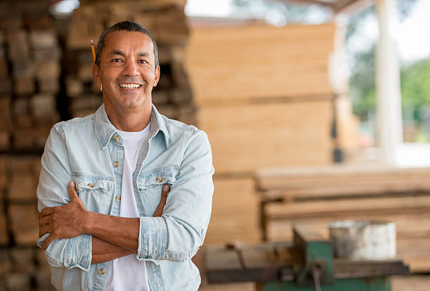 istock Carpenter at his carpentry looking happy 538144147