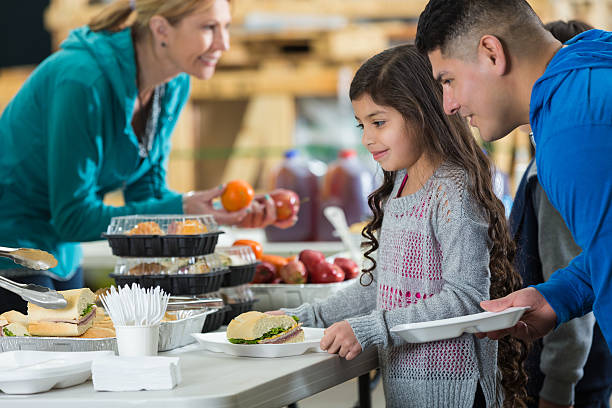 istock Father and daughter having meal in charity soup kitchen 538145113