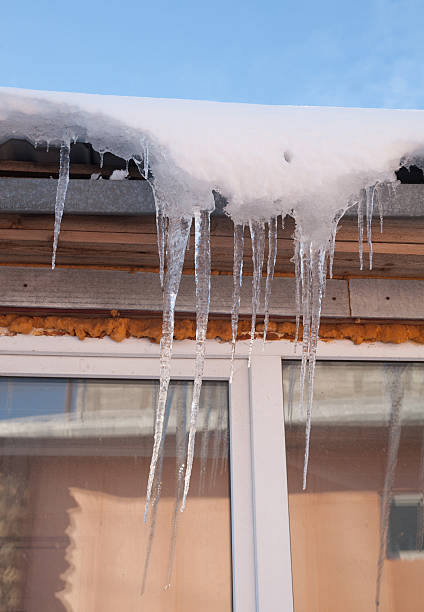 istock Icicles on eaves house on sunny day 538146387