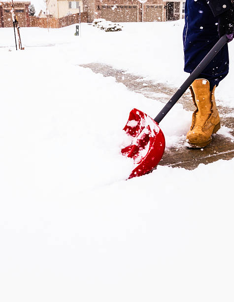 istock Man shoveling snow from driveway in winter storm 538149229