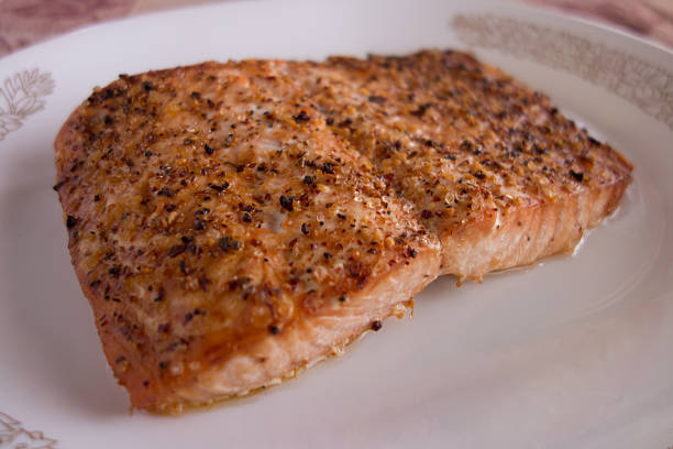 istock Broiled salmon with spices on white plate 538149583