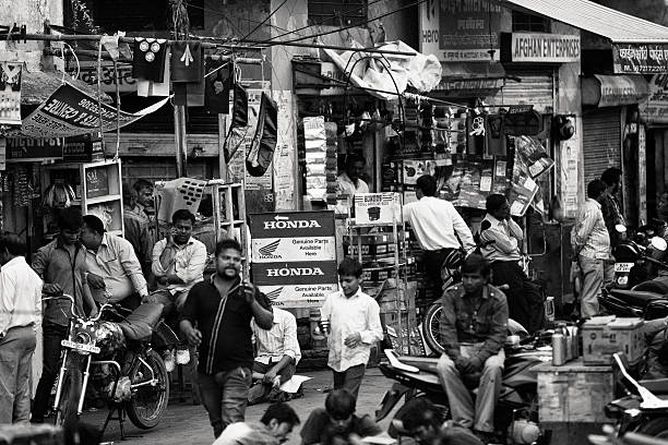 Jaipur, Rajasthan, India - March 7, 2015. Many people scatter a busy street of repair shops in Jaipur, India.
