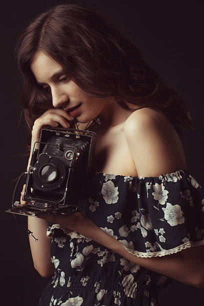 istock Pretty brunette woman with retro camera 538155632