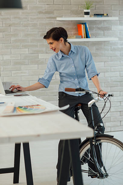 istock Female Architect Sitting On Her Bicycle And Using Laptop. 538158124