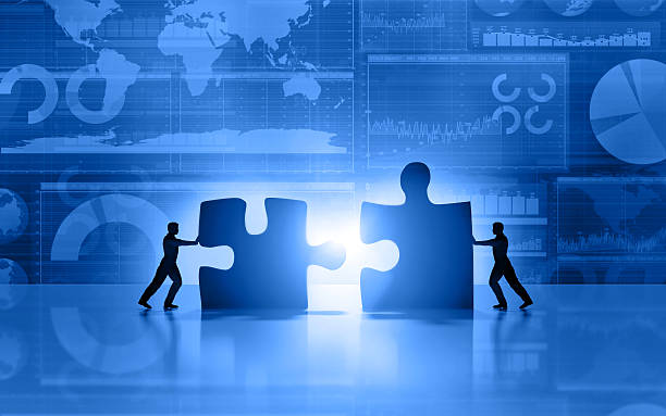 Business men teamwork joining puzzle on blue background