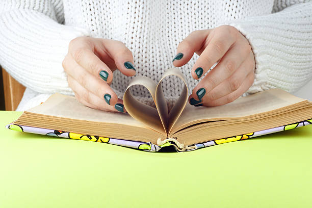 istock Young girl reading an  open book  old book. 538160306