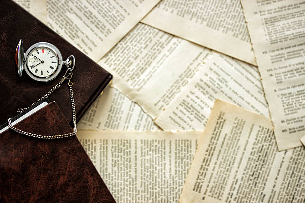 istock Old pocket watch and a book lying on the table 538160730