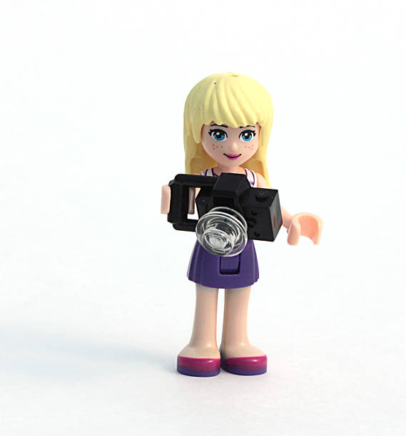 Castle Rock, Colorado, USA - Feb. 3, 2015: Studio shot of a Lego minifigure girl photographer isolated on white background. Lego minifigures are a popular line of plastic construction toys that are manufactured by the Lego Group, a privately held company based in Denmark.