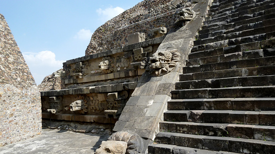 San Juan Teotihuacan, State of Mexico, Mexico - January 03, 2013: Detail of the staircase and decorations in form of serpents heads on the Temple of the Feathered Serpent, also known as the Temple of Quetzalcoatl, and the Feathered Serpent Pyramid in Teotihuacan.
