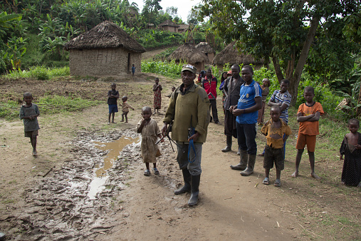 Chai, North Kivu, DRC- March 29, 2014: FDLR soldier walking with Rwandan refugees in Chai, North Kivu, DR Congo.