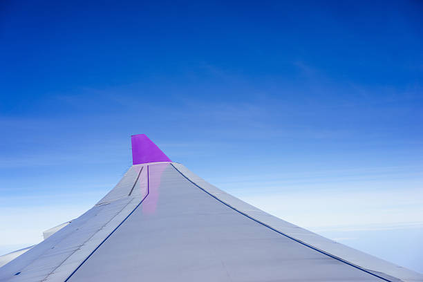 istock Wing of an airplane flying above the clouds 538163053