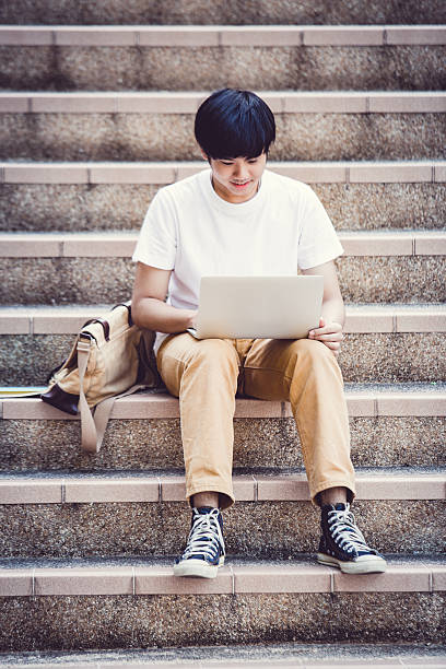 istock Smiling college student sitting on staircase 538163532