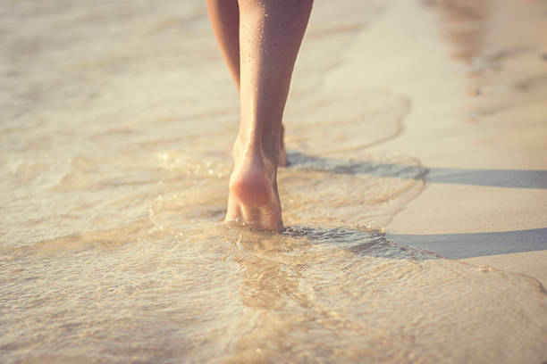 istock Woman walking on beach 538163991