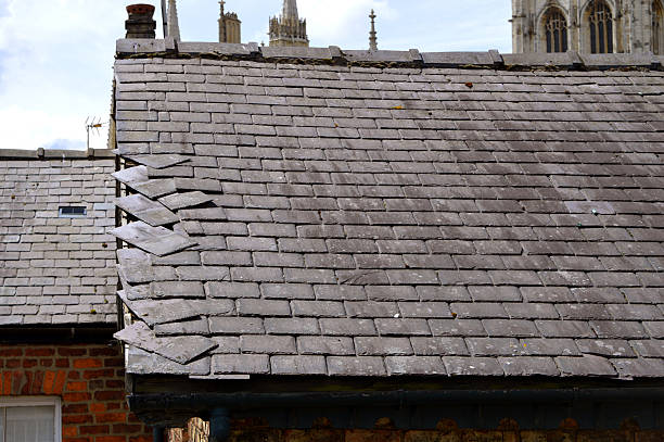 Loose slates on a house roof Loose slates on a house roof york yorkshire photos stock pictures, royalty-free photos & images