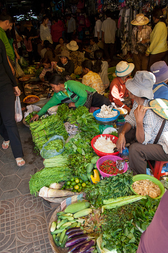 Siem Reap, Cambodia - May 3, 2013: A busy scene of shoppers and market vendors in Siem Reap Market in Cambodia