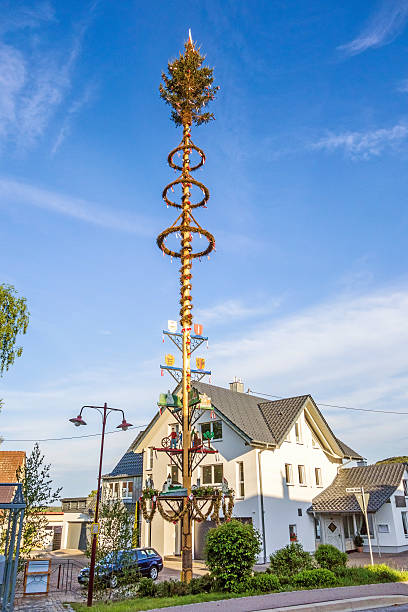 May pole in Bartholomae, Germany Bartholomae, Germany - May 26, 2016: May pole (Maibaum) at village centre whitsun stock pictures, royalty-free photos & images