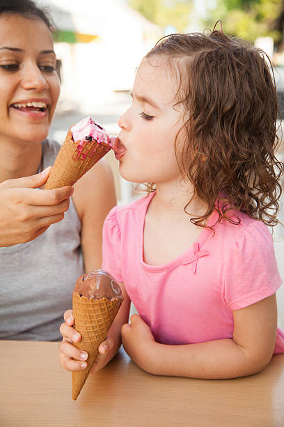 istock Mother and daughter eating ice cream 538168342