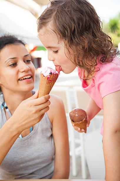 istock Mother and daughter eating ice cream 538168904