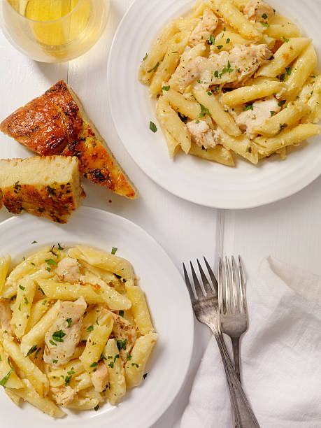 Chicken Alfredo with Penne Pasta Chicken Alfredo with Penne Pasta- Photographed on a Hasselblad H3D11-39 megapixel Camera System cooked selective focus vertical pasta stock pictures, royalty-free photos & images