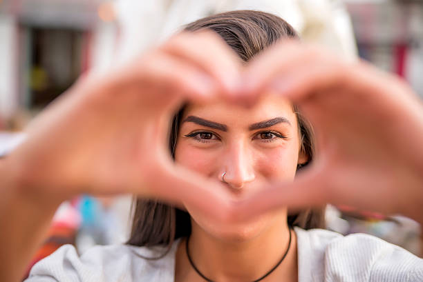 istock girl holding hands in heart shape 538172324