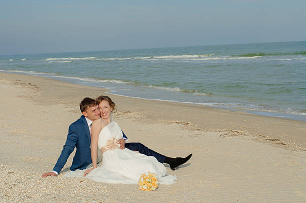 istock Young bride and groom on the beach 538176239