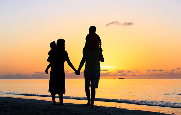 istock happy family with two kids walking at sunset 538177766