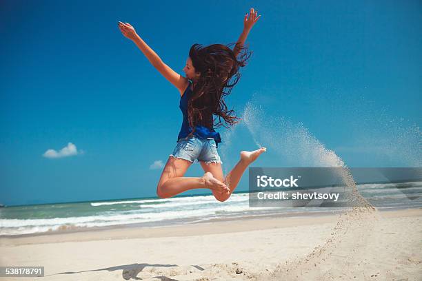 Happy Girl Jumping On The Beach Stock Photo - Download Image Now - 2015, Adult, Asia
