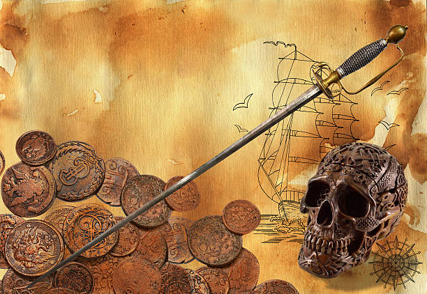 Low key image of human skull and a pile of gold coins, isolated on black.