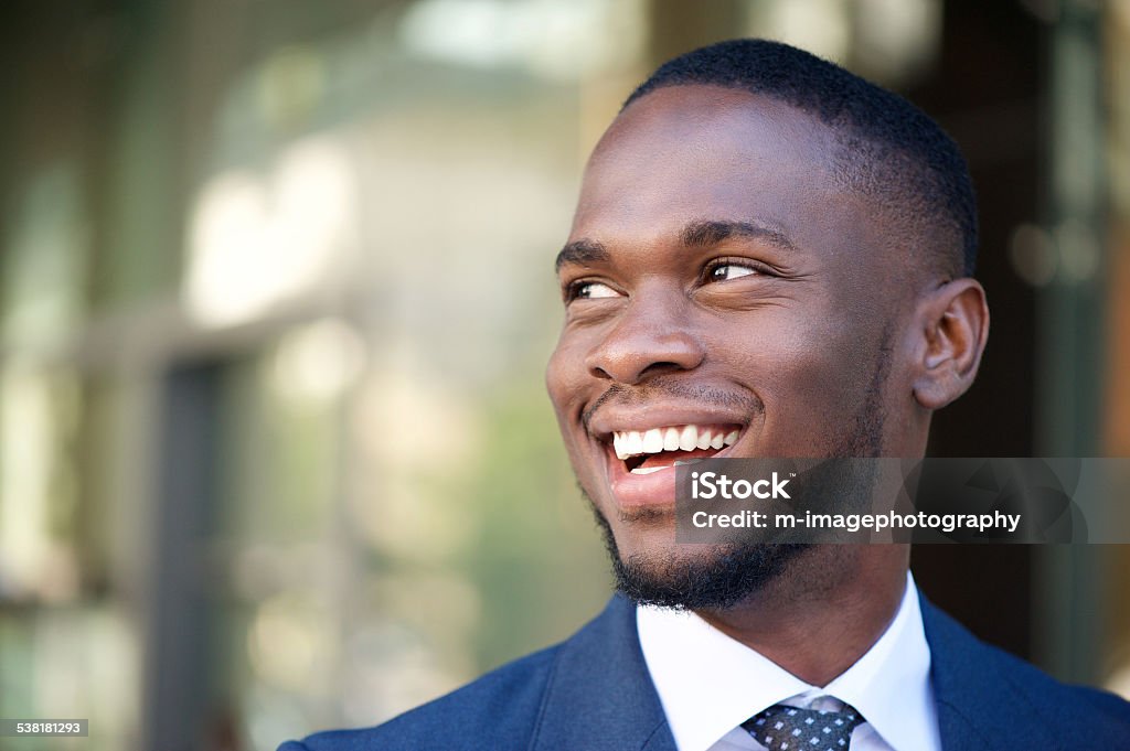 Close up smiling business man in the city Close up portrait of a smiling business man in the city Men Stock Photo