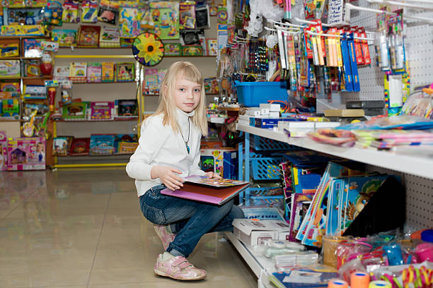 istock Girl buys school accessories. 538181379
