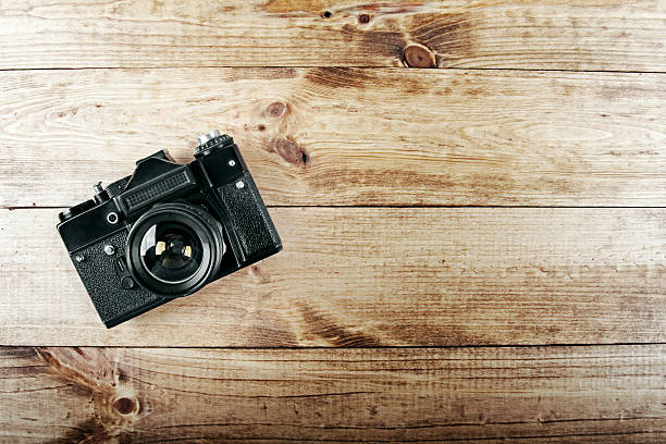 istock old vintage photo camera on wooden table 538181439