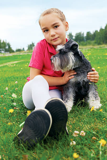 istock girl and her dog lying on the grass 538183063