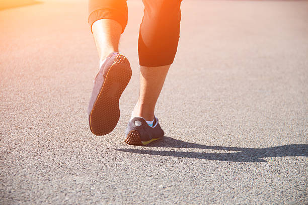 istock Closeup of a runner feet running on the road 538183190